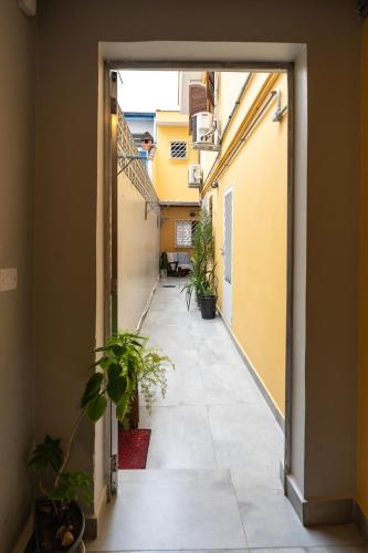 an open door to a hallway with potted plants at Hostel B2B SP in Sao Paulo