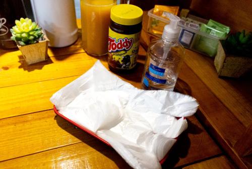 a paper bag on a table with a bottle of drink at Hostel B2B SP in Sao Paulo