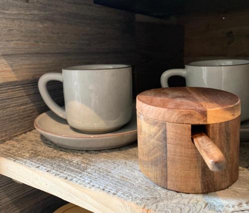 two coffee cups sitting on a wooden table at Une Histoire de Loup 
