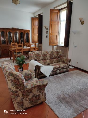 a living room with a couch and a chair at casa cardeal saraiva in Ponte de Lima
