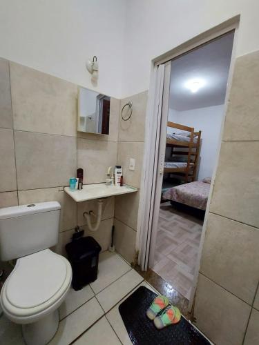 a small bathroom with a toilet and a sink at SUITE CENTRAL BECO DAS FLORES in Jericoacoara