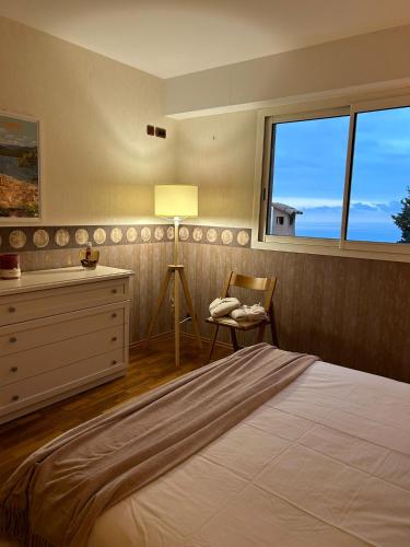 a bedroom with a bed and a dresser and a window at Villa The View in Villefranche-sur-Mer