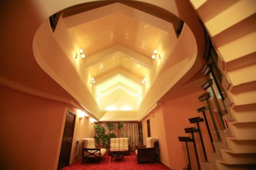 a hallway with a coffered ceiling and a staircase at Hotel Mara in Baia Mare