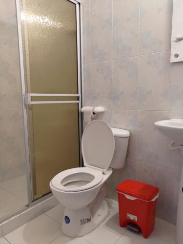 a bathroom with a toilet and a shower at Hotel Amazon in Florencia