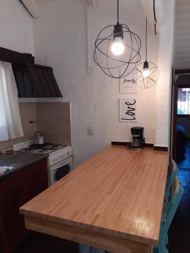 a kitchen with a wooden table in a kitchen at Casita 2 ambientes in San Carlos de Bariloche