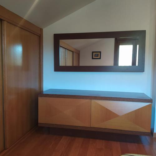 a dressing room with a mirror on the wall at A de Bego in Mougás