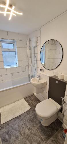 a bathroom with a toilet and a sink at 1 bedroom service apartment with Netflix in West Thurrock