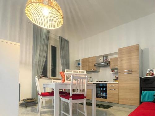 a kitchen with a table and chairs in a room at Poggio della Guardia - Montegrosso Rooms in Montegrosso