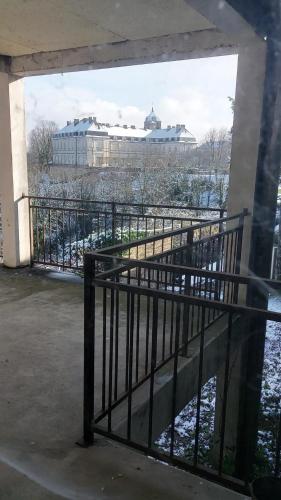 a balcony with a fence and a view of a building at gite du chateau de champlitte in Champlitte-et-le-Prélot