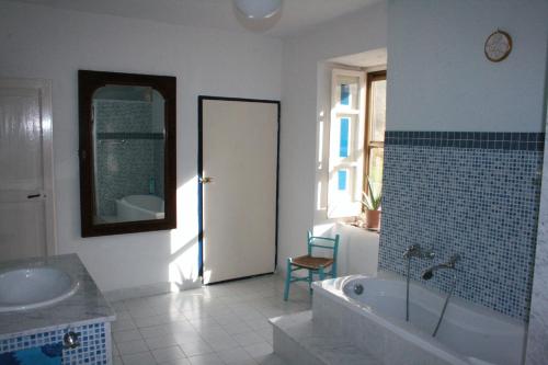 a bathroom with a tub and a sink and a mirror at Art & Breakfast in Ripabottoni