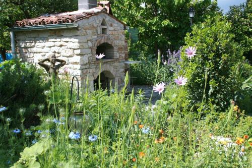a stone house in the middle of a garden at Art & Breakfast in Ripabottoni
