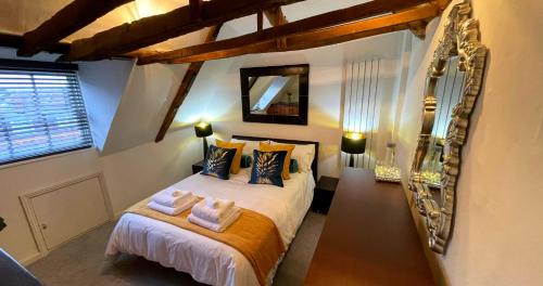 a bedroom with a bed with towels on it at Stunning Luxury Apartment in Central Lymington in Lymington