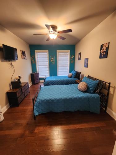 a bedroom with two beds and a ceiling fan at Spacious Newly Renovated Home in Atlanta