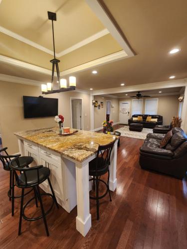 a kitchen with a large island in a living room at Spacious Newly Renovated Home in Atlanta