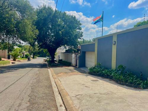 a street with a blue building with a flag on it at Timebridge Mansions in Johannesburg