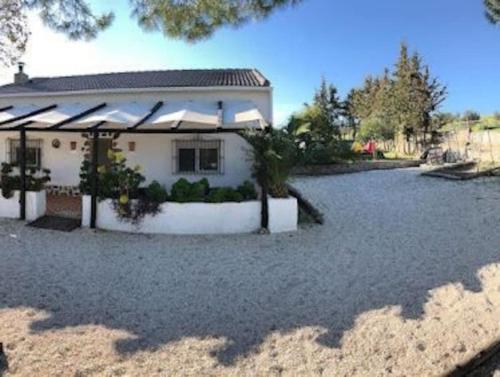 a house with a gravel driveway in front of it at Casa Rural La Casa de Lolo in Minas del Castillo de las Guardas