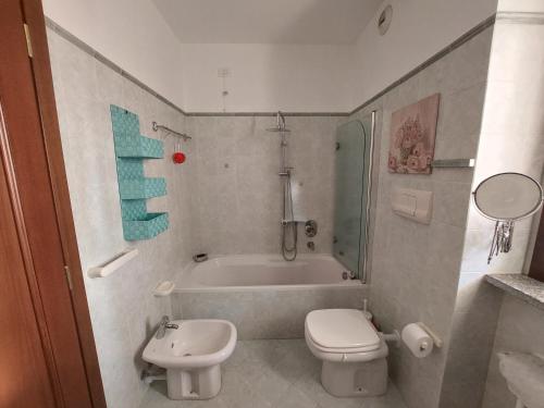 a bathroom with a tub and a toilet and a sink at Expo Room Milano in Milan