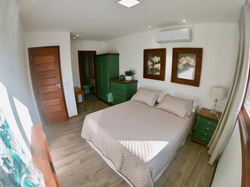 um quarto com uma cama grande e armários verdes em Apartamento na Vila de Barra Grande - Bahia em Barra Grande