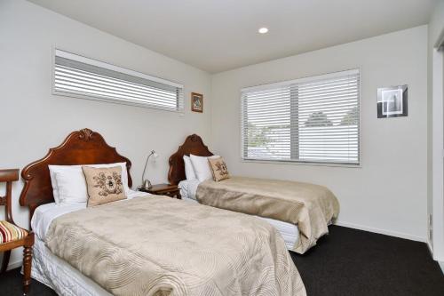a bedroom with two beds and a window at Jeffreys Road - Christchurch Holiday Homes in Christchurch
