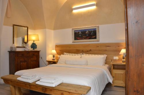 a bedroom with a large bed with two towels on it at B&B Corte Santa Maria in Rovereto