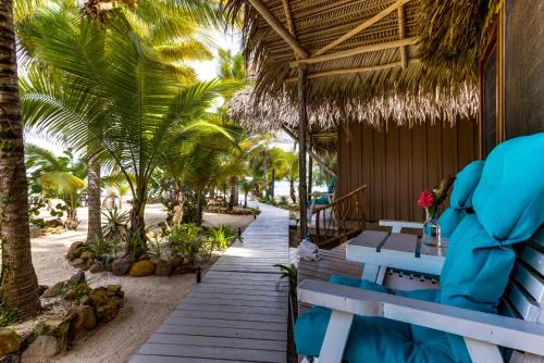 a resort with blue benches and palm trees on the beach at Azure Del Mar in Maya Beach
