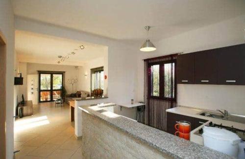 a kitchen with a counter top and a living room at Apartment with pool Adria in Marčana