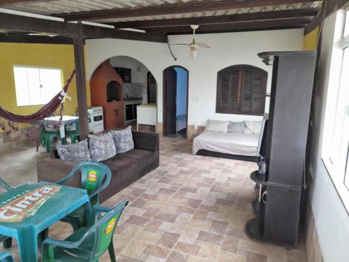 a living room with a couch and a stove at Cantinho da Bethânia in São Pedro da Aldeia