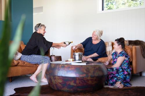 a group of people sitting in a living room at White Rock Accommodation in Martinborough 
