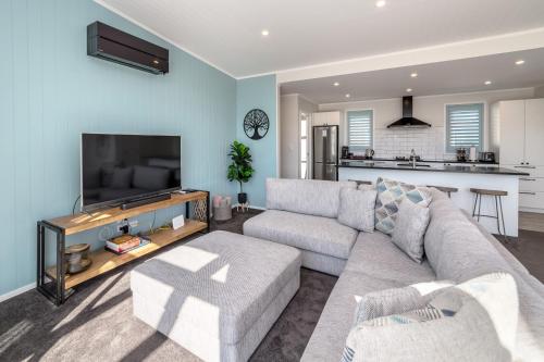 a living room with a couch and a tv at Blue Bungalow in Martinborough 