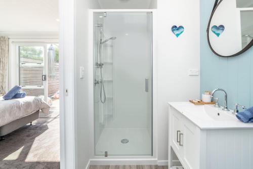 a bathroom with a shower and a sink at Blue Bungalow in Martinborough 