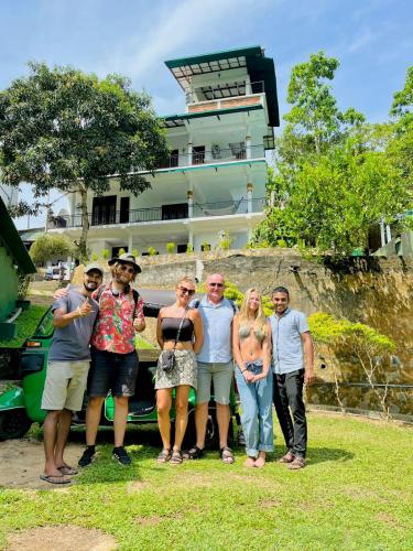 a group of people standing in front of a bus at Green Hill Paradise Villa in Unawatuna