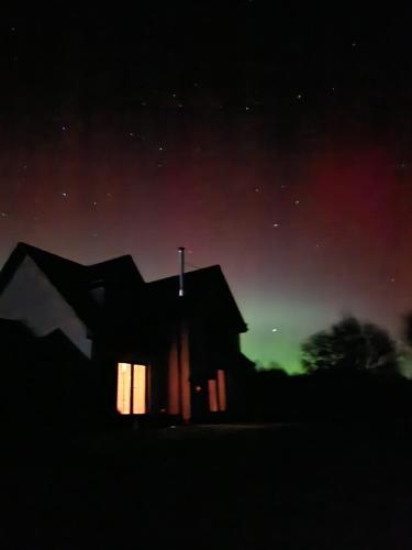 a house at night with the lights on at Birch Hollow, Fort William with outdoor fire pit in Fort William