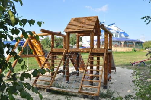 
a small child's playground with a wooden bench at Hotel Vivat Provincia in Takhtaulove
