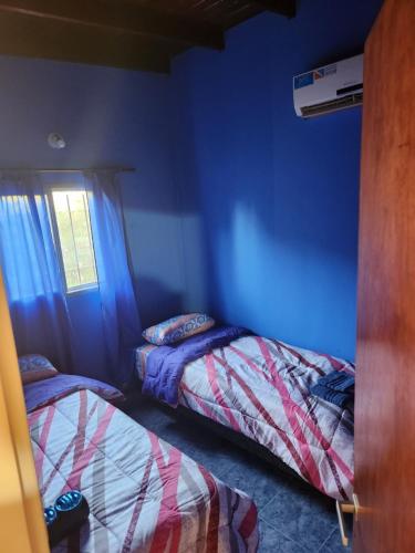 a bedroom with two beds and a window at Lindo y cómodo dpto in Garín