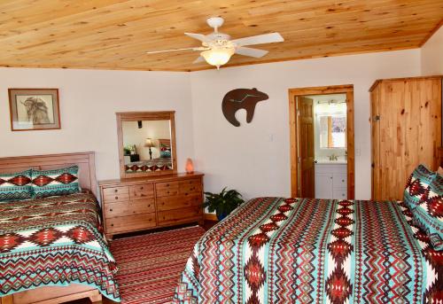 a bedroom with two beds and a ceiling fan at Red Moon Lodge in Moab