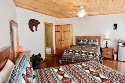 a bedroom with two beds and a ceiling at Red Moon Lodge in Moab