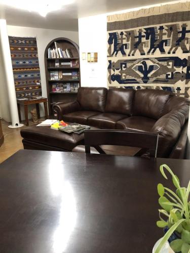 a living room with a leather couch and a table at Red Moon Lodge in Moab