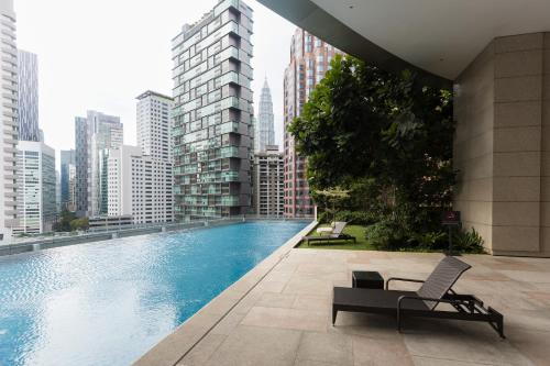 a swimming pool in the middle of a city with buildings at Opus Bukit Bintang in Kuala Lumpur