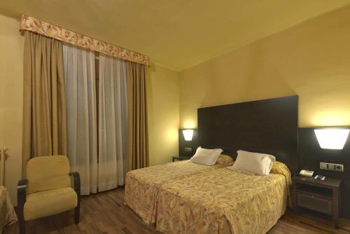 Katil atau katil-katil dalam bilik di Hotel Restaurant Pessets & SPA