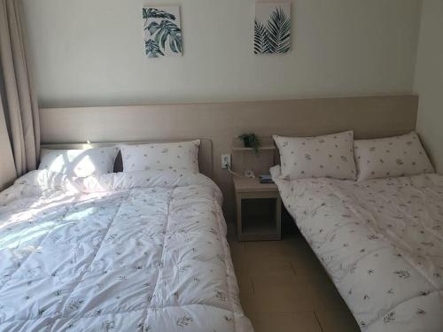 a bedroom with a bed and a nightstand with a bed sidx sidx at AREX Hongik univ Unit 201 in Seoul