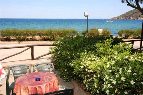 a table and chairs with a view of the ocean at Ammiraglio in Campese