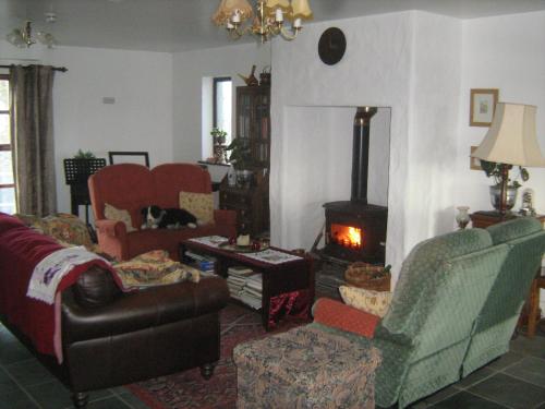 a living room with a couch and a wood stove at Slemish Barn Hostel in Ballymena