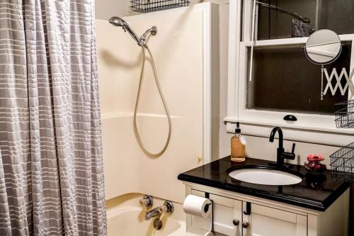 a bathroom with a shower and a sink at Lakefront getaway *cozy & peaceful *dock & swings 