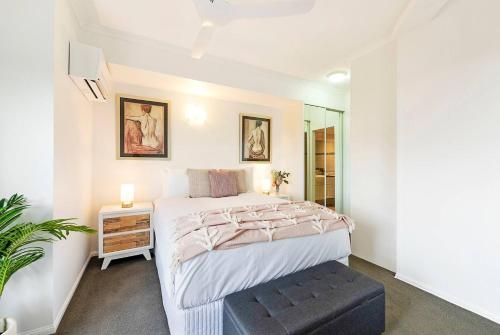 a bedroom with a bed and a stool in it at Captain's Lookout - Penthouse Living at Cullen Bay in Darwin