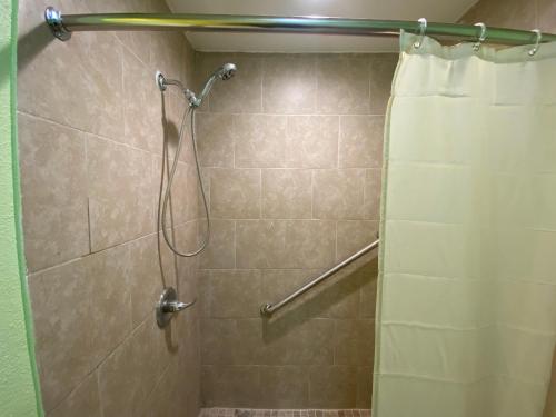 eine Dusche mit Duschvorhang im Bad in der Unterkunft SUNSET HOTEL - Downtown San Francisco in San Francisco