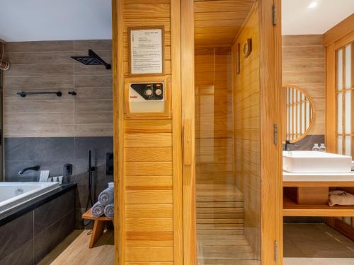 a bathroom with a shower and a sink at Yoko Onsen Quang Hanh in Cẩm Phả