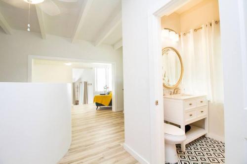 a white bathroom with a sink and a mirror at Bayside Grande Villa in Clearwater Beach