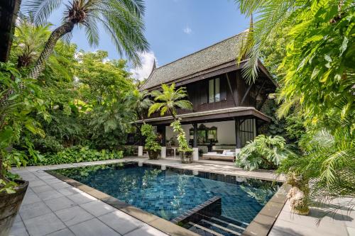 an exterior view of a villa with a swimming pool at Villa Mahabhirom - SHA Plus in Chiang Mai