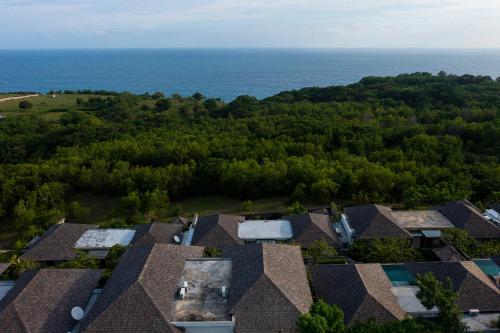 an aerial view of roofs of houses and the ocean at Moritz Palm Villa in Uluwatu