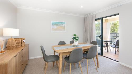 a dining room with a table and chairs at The Sands Resort at Yamba in Yamba